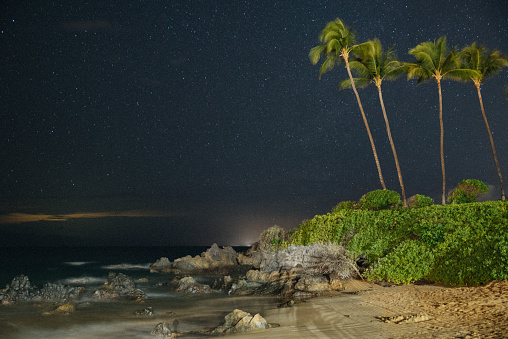 A beautiful shot of the beachfront at night in Maui