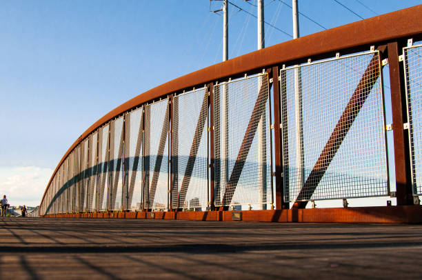 istock Long, metal bridge on a blue sky background 1459290883