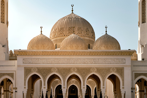 The facade of the famous Zabeel Grand Mosque in Dubai against a blue sky on a sunny day