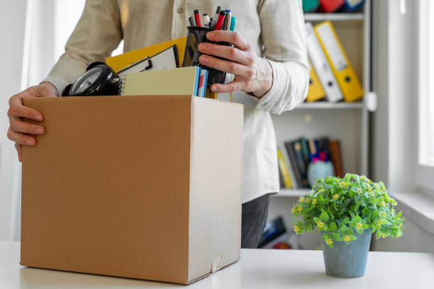 Sad dismissed worker taking his office supplies with him