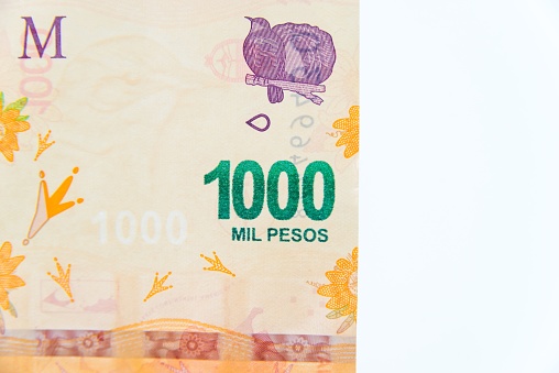 A close up of a thousand Argentinean pesos bill on white background