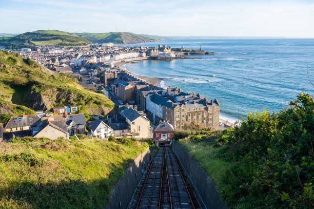 Railroad taking to Aberystwyth town of Wales with a view of the sea A railroad taking to Aberystwyth town of Wales with a view of the sea cardigan wales stock pictures, royalty-free photos & images