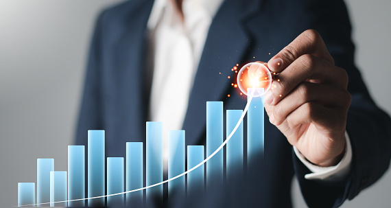 Businessman analyzing sales data graph growth on strategy modern interface icons. Digital online marketing, Planning analysis and business development.