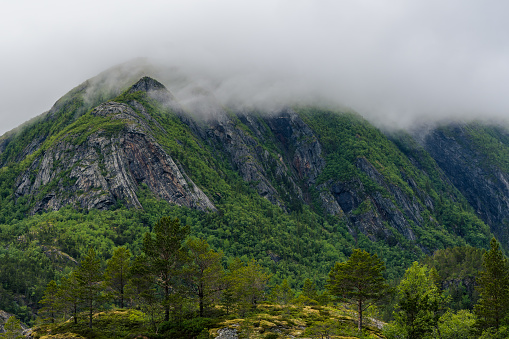 High mountains in northern Norway covered in clouds and mist