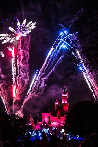 los angeles, United States – January 24, 2018: An image of fireworks and a castle in the red lights at Disney Land of Los Angeles at night.
