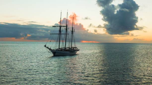 istock Large sailing pirate ship on a sea at sunset 1459298213