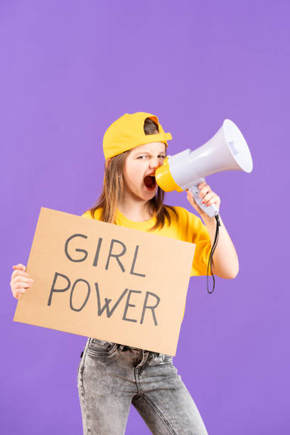 menina manifestante mostrando mensagem de girl power em um papelão - outdoors looking at camera little girls child - fotografias e filmes do acervo