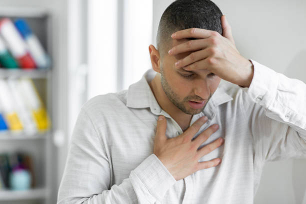 Man suffering from breathing problem stock photo