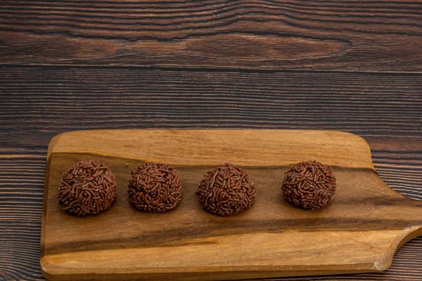 istock Closeup of chocolate Brazilian Brigadeiro on a cutting board with copy space 1459299546
