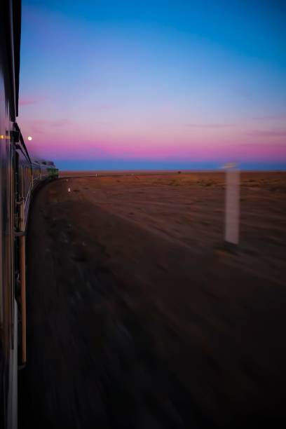 istock Vertical shot of train ride through desert with motion blur during sunset. 1459299635
