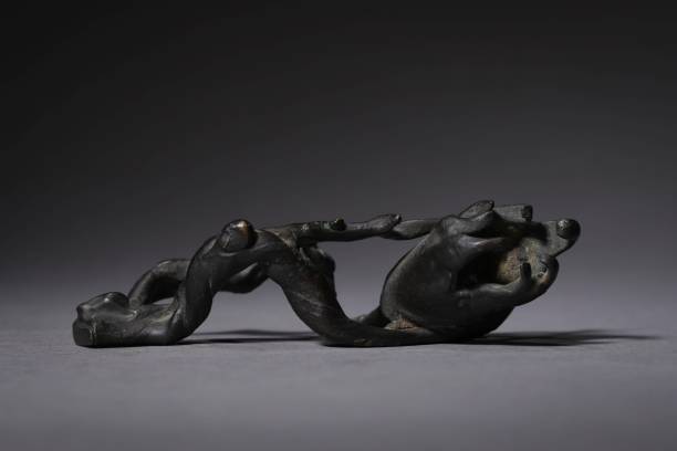 istock Black sculpture depicting a branch on a gray background in China 1459301855