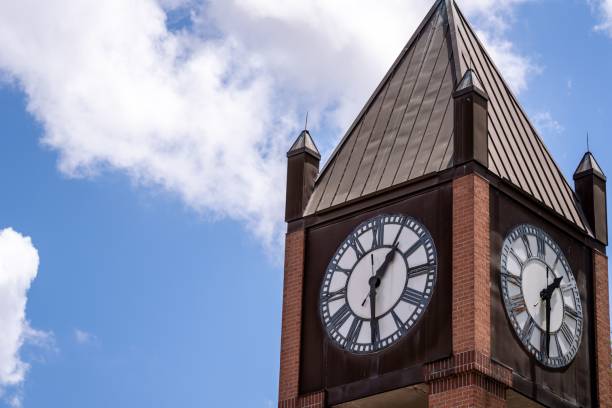 A clock tower building in Downtown Houston, Texas in cloudy sky background