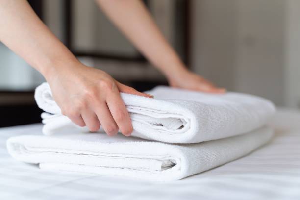 istock Person stacking towels for a room service in a hotel 1459304746
