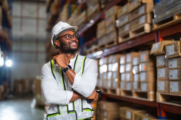 istock Portrait of a black warehouse manager standing with a barcode reader in a large distribution center 1459304764
