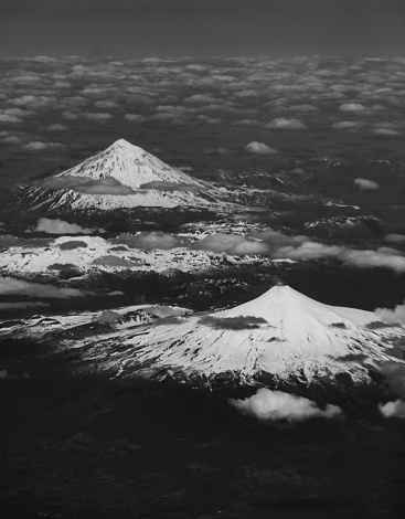 An aerial grayscale view of the snow covered summits of the Mountains of Torres del Paine