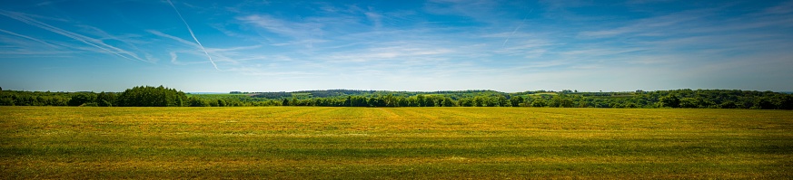 Panorama shot of an agricultural field in the sloping hills of the Condroz in Wallonia, Belgium. Beauty in nature.