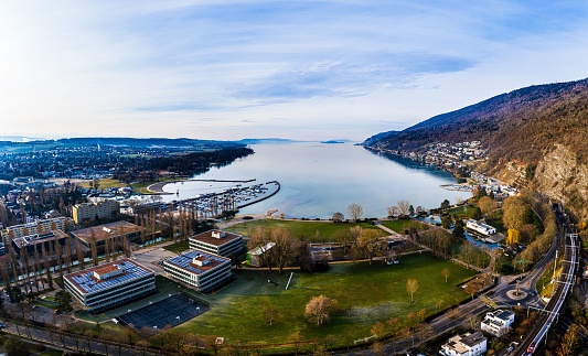 A drone shot of the Lake Biel and the city of Biel-Bienne on a sunny day in western Switzerland