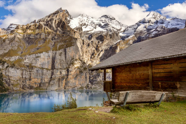 Oeschinnensee, wooden chalet and Swiss Alps, Switzerland. Amazing tourquise Oeschinnensee lake, wooden chalet and Swiss Alps, Berner Oberland, Switzerland. lake oeschinensee stock pictures, royalty-free photos & images