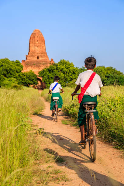 istock Burmese school children riding a bicycle in Bagan, Myanmar 1459308729