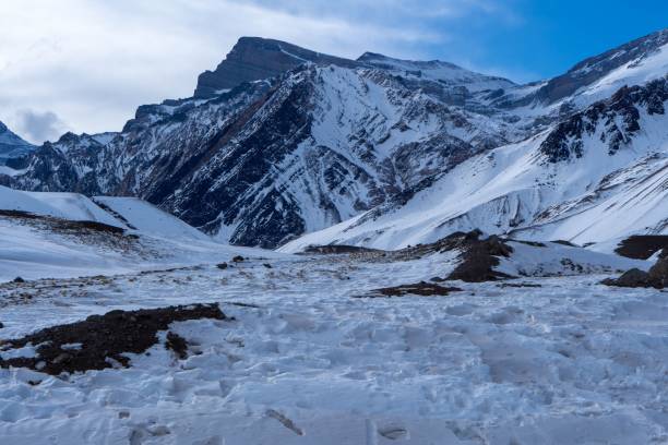 istock Image of mountains covered by snow under the cloudy blue sky. 1459309194
