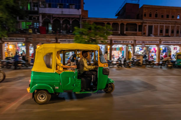 Indian man drives auto rickshaw (tuk-tuk), India Indian man drives auto rickshaw (tuk-tuk) on streets of Rajasthan, India. auto rickshaw taxi india stock pictures, royalty-free photos & images