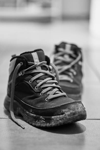 istock Grayscale vertical shot of a dirty hiking boot 1459309368