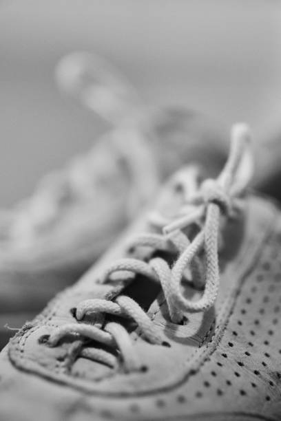 istock Vertical grayscale closeup of the sneaker laces. Selected focus. 1459309385