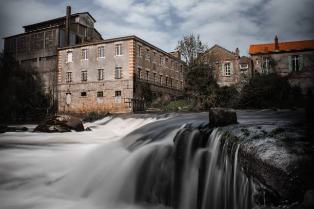 istock Long exposure river with old buildings in the background on a cloudy day 1459309417