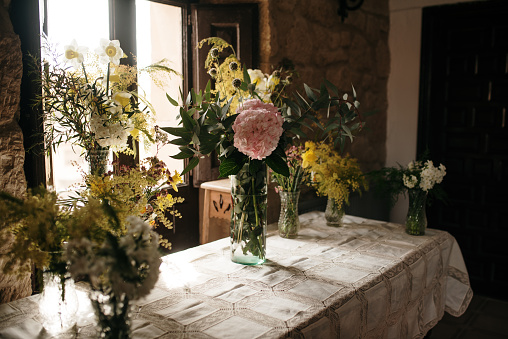 A table decorated with vases and flower bouquets