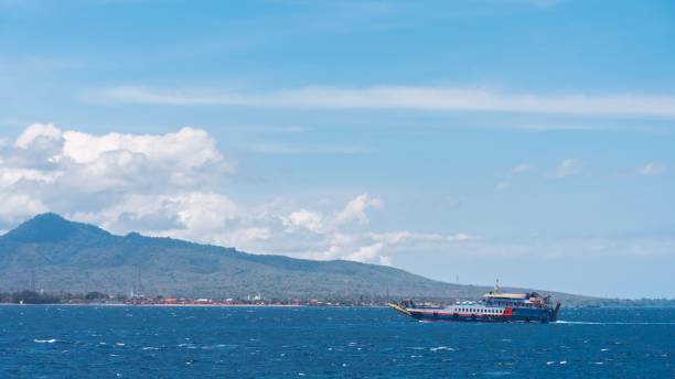 istock Ship in the open blue sea under the white cloudy sky. 1459309735