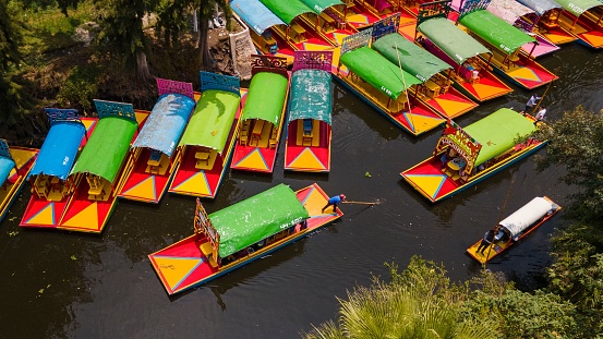Aerial shot of colorfully painted boats in Xochimilco, Mexico City. One of the most typical places.
