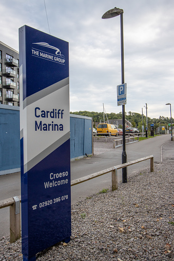 Welcome Sign to Cardiff Marina in Wales, UK, with a holding company logo and phone number visible.