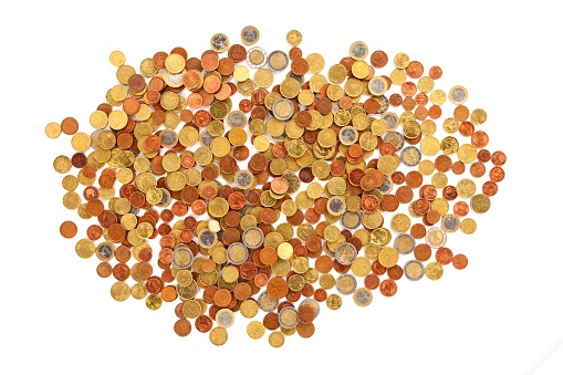 A view of a lot of gold and orange Euro coins on a white background