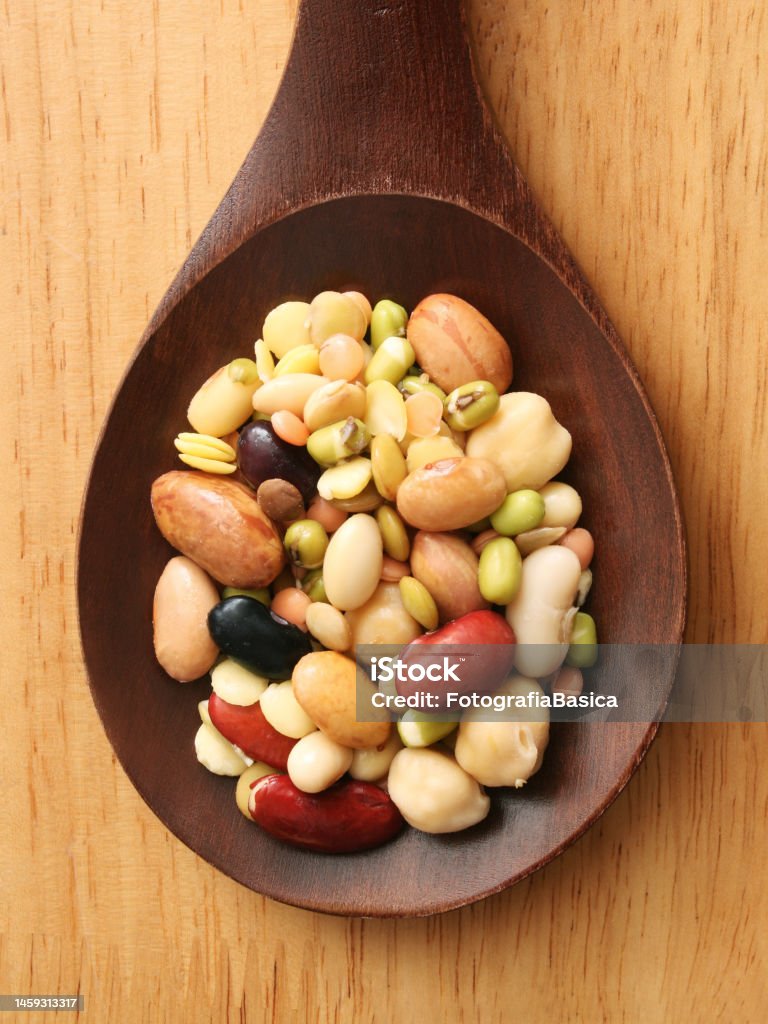 Soaked legumes mix Top view of wooden spoon with a mix of soaked legumes on it Bean Stock Photo