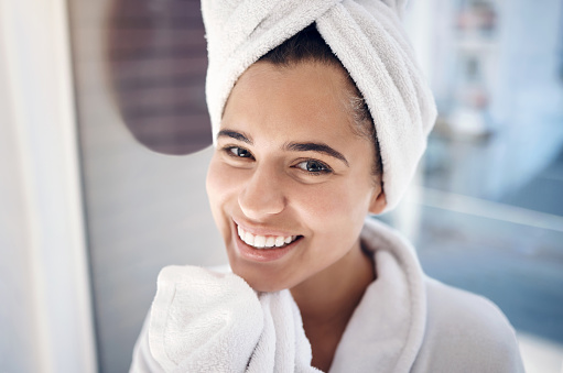 Woman, spa and portrait smile for hygiene, wash or beauty skincare or cosmetic bathroom treatment. Happy female face smiling with teeth in happiness or satisfaction for facial care or luxury cleanse