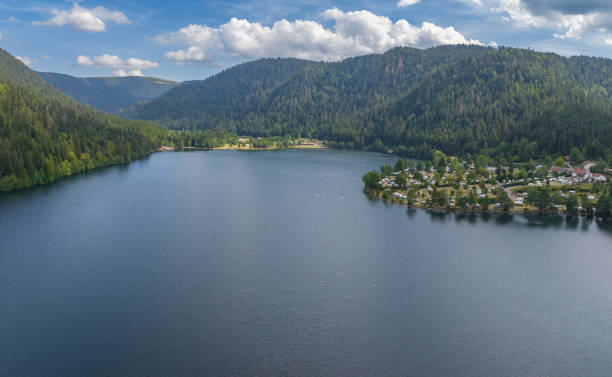 Longemer lake in the French Vosges region at Xonrupt-Longemer during a beautiful summer day. Panoramic drone view from above.
