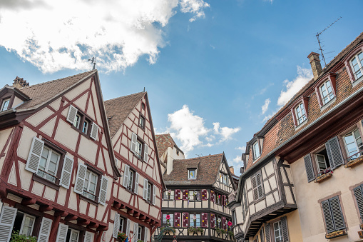 Colmar city street view in the French Alsace during a summer day. Colmar is famous for its traditional architecture with timber framing in the old town and canals that run through the city.