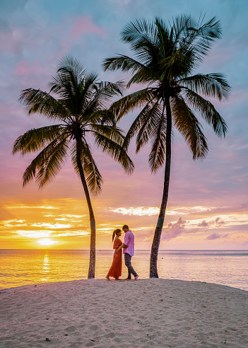 Saint Lucia Caribbean Island, couple watching sunset under a palm tree during vacation at the tropical Island St Lucia