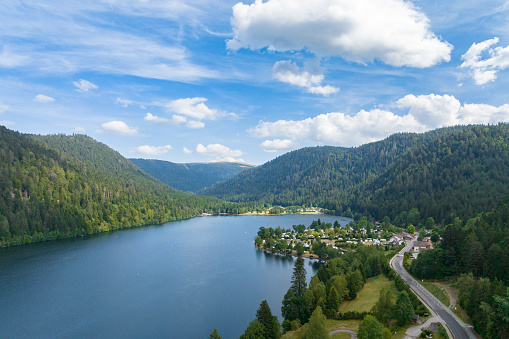 Longemer lake in the French Vosges region at Xonrupt-Longemer during a beautiful summer day. Panoramic drone view from above.