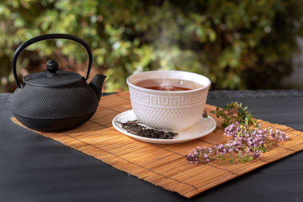 istock Cup of tea and a teapot on the table outside 1459316342