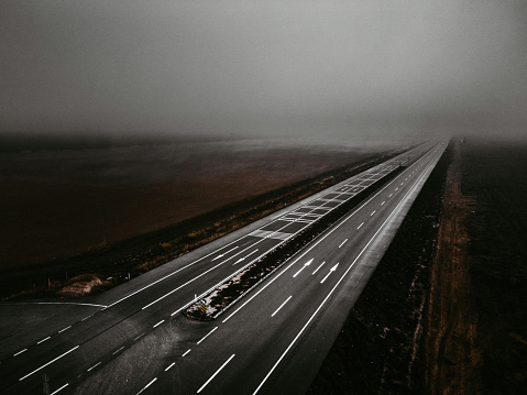 Highway road in dense fog. Aerial shot