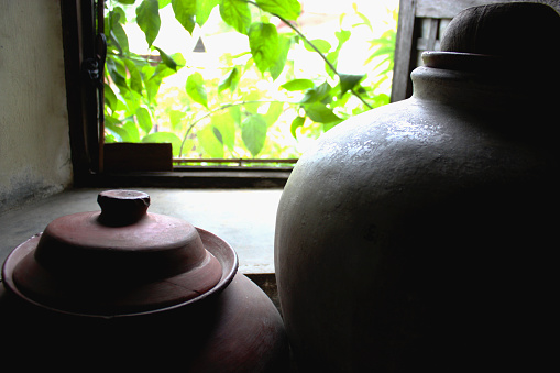 Olden pots used for water inside an ancestral house.
