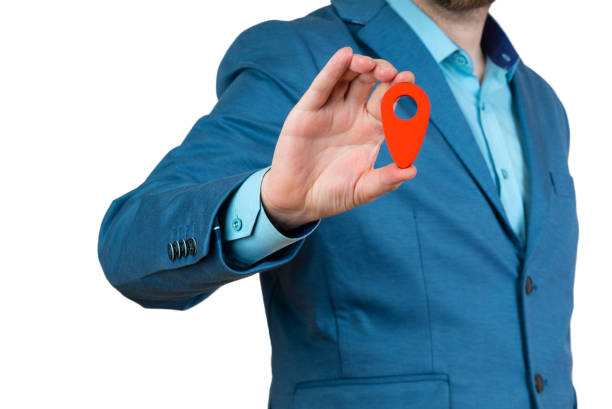 istock Businessman holding a red location pin pointer 1459318459