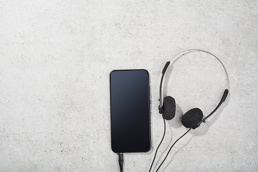 Male silhouette with headphones on white background.