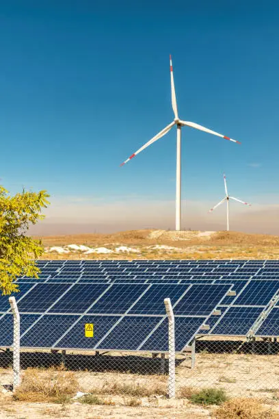 Photo of Solar photovoltaic panels and wind turbines. Green energy environmental concept