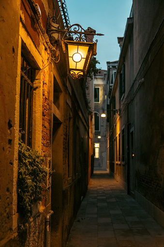 A narrow street in the city of Venice, Italy at night