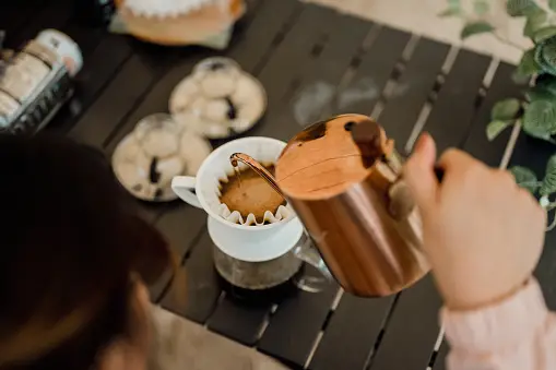 https://media.istockphoto.com/id/1459324820/photo/an-asian-woman-pouring-hot-water-from-kettle-to-make-drip-coffee-at-campsite.webp?b=1&s=170667a&w=0&k=20&c=OerYqoq5awRn1cnUcFvc7CVXuYN_2ICkuokegWDNFgU=