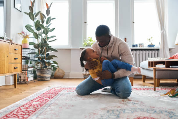 istock Man playing with boy and spending leisure time at home 1459325937