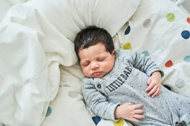 istock Newborn baby sleeping peacefully in his cradle 1459326356