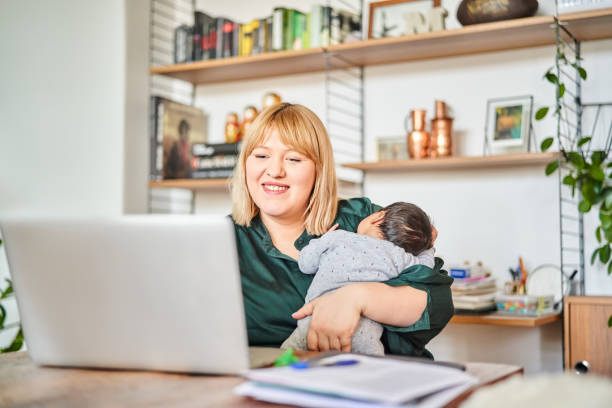 istock Single mother working at home while carrying baby 1459326550